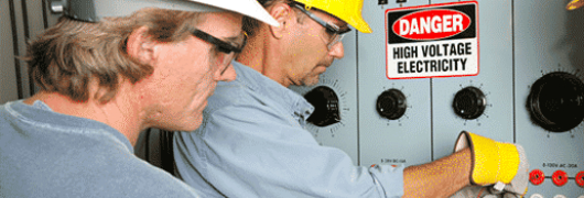 men working on high voltage panel