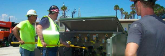 men working electrical panel for military